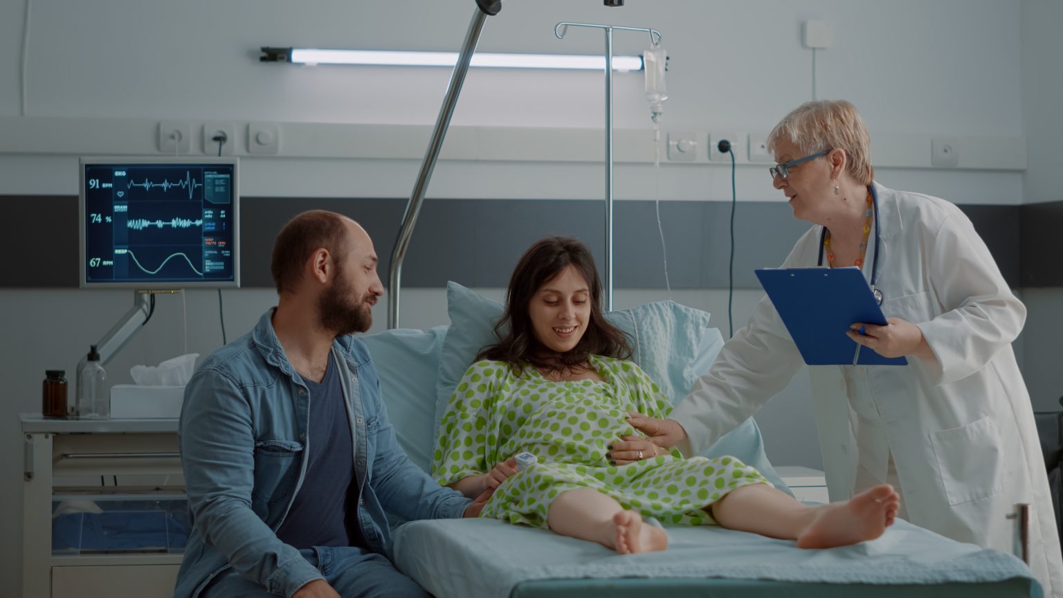 young-pregnant-adult-getting-support-from-doctor-while-waiting-with-man-hospital-ward-caucasian-woman-expecting-child-maternity-bed-obstetrician-consulting-pregnancy-healthcare-1536x864